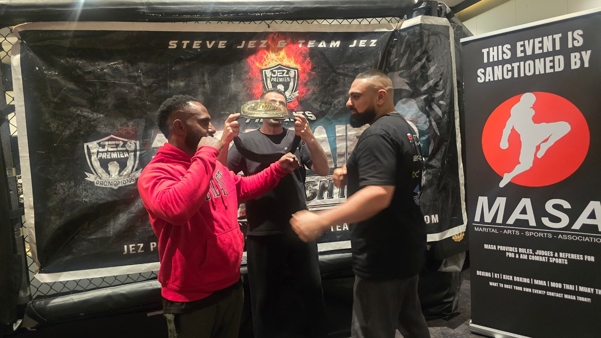 PNG coach and opponent face off holding a championship belt at a Jez Premier Promotions fight night